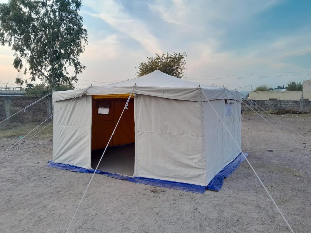 Make: Single Fly Two-Fold Tent with Mud Flap All Around the Tent. Size: 4 x 4 Mtr. Area: 16 M². Central Height: 2.5 Mtr. Wall Height: 1.98 Mtr. Material Outer Fold: Cotton Canvas Cover Waterproof and Rot Proof Weight 435 gsm ± 5%. Inner Fold: Cotton Lining Yellow Fabric 130 gsm ± 5%. Color: Natural White. Doors: 2 Doors. Windows: 2 Windows. Frame: Iron Pole, Standing Pole & Wall Poles, 12 Cotton Rope. Accessories: Pegs & Hammer. Packing: In one bale with all accessories. Weight: 40 Kg ± 5%.